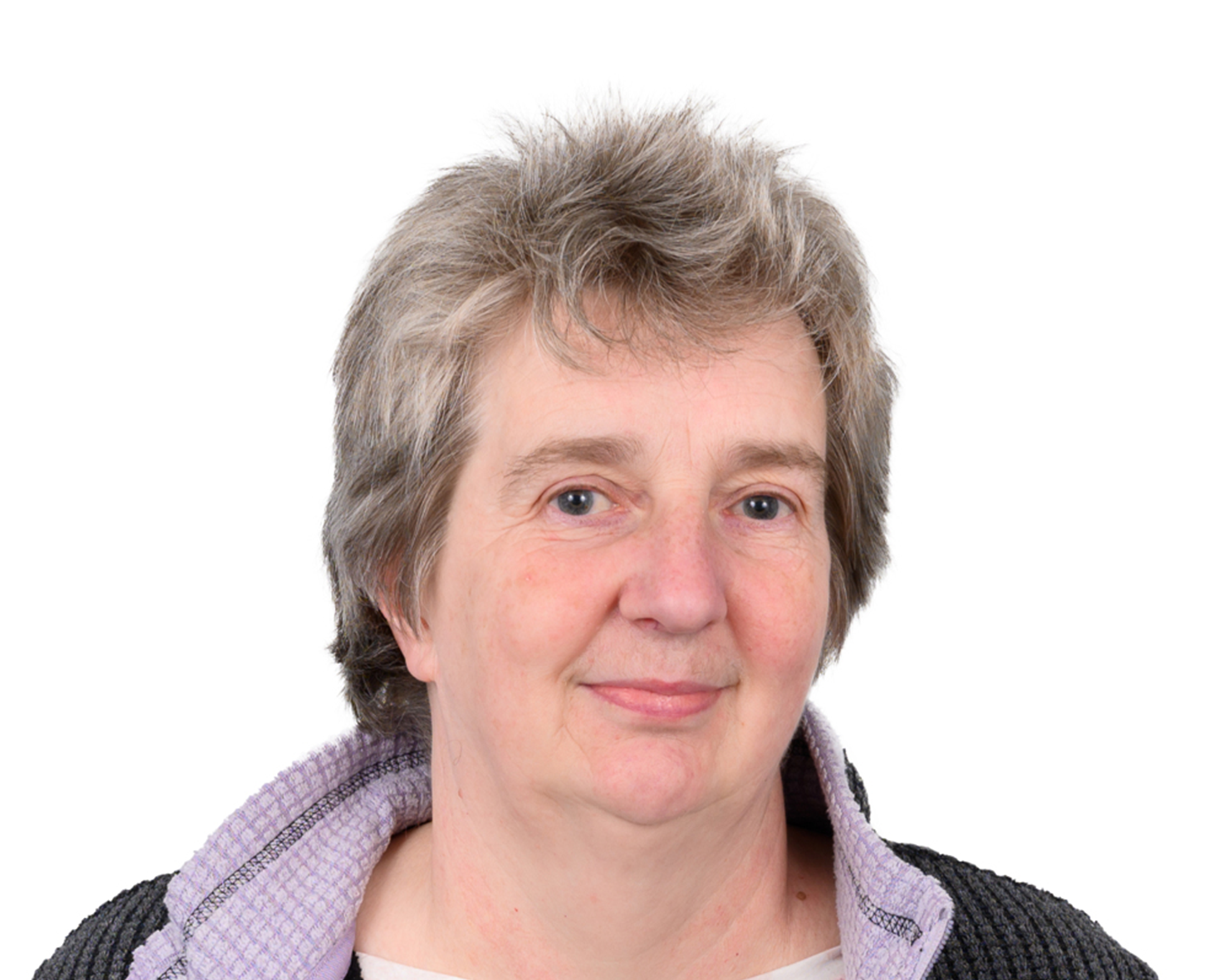 Portrait photograph of a person against a white background, appearing to be a staff or professional headshot taken indoors.