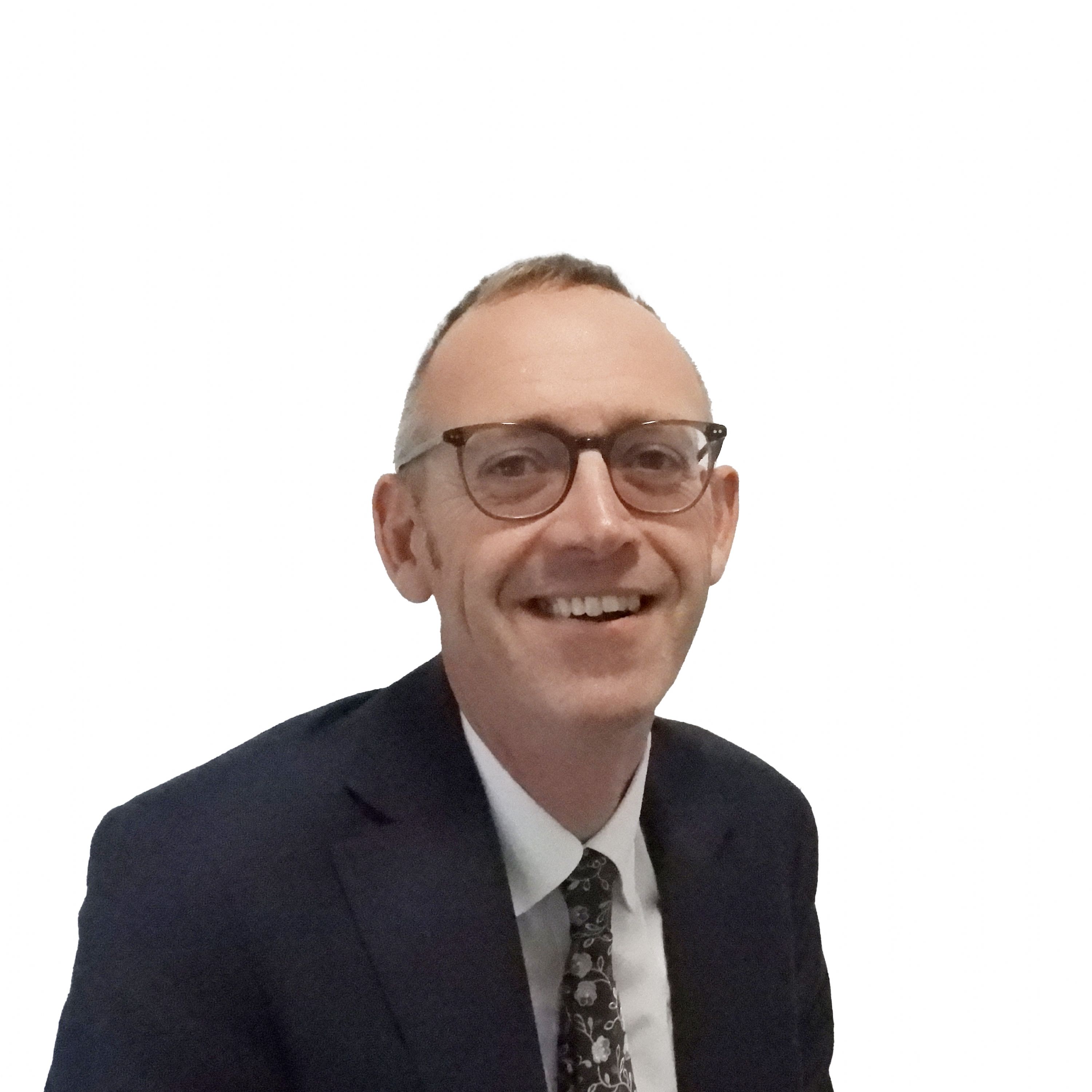 Professional headshot photograph of a staff member wearing glasses and formal business attire against a plain white background.